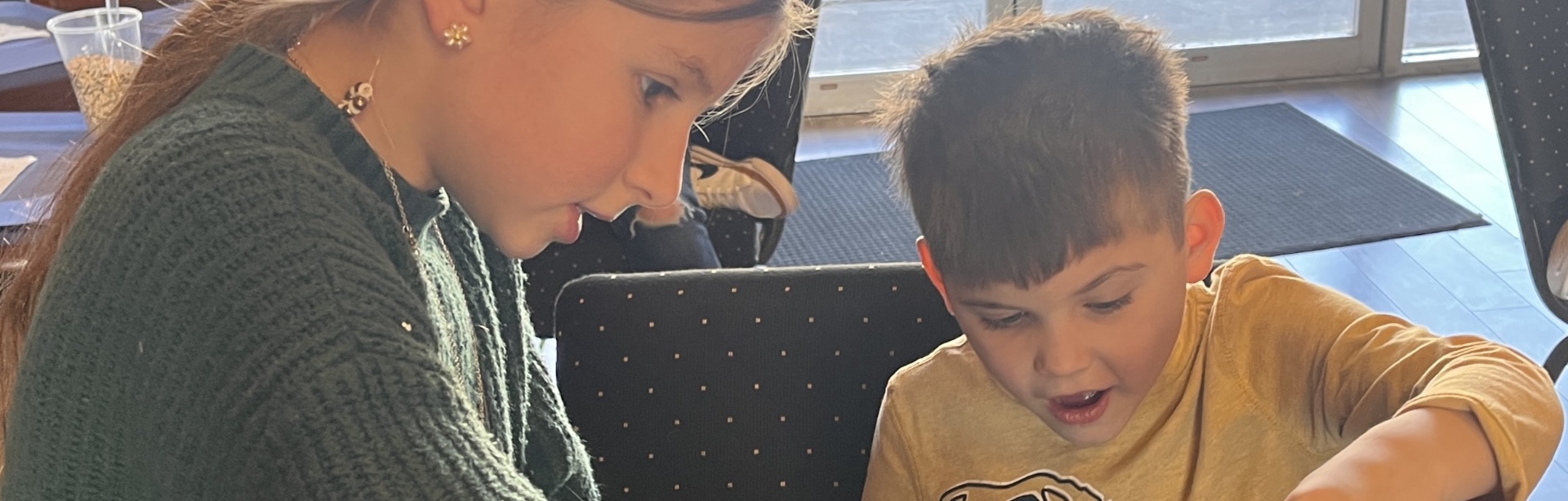 Children working together at a homeschool classroom table
